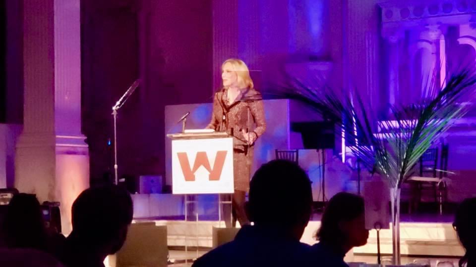 Heather Rim speaking at a podium during a leadership event