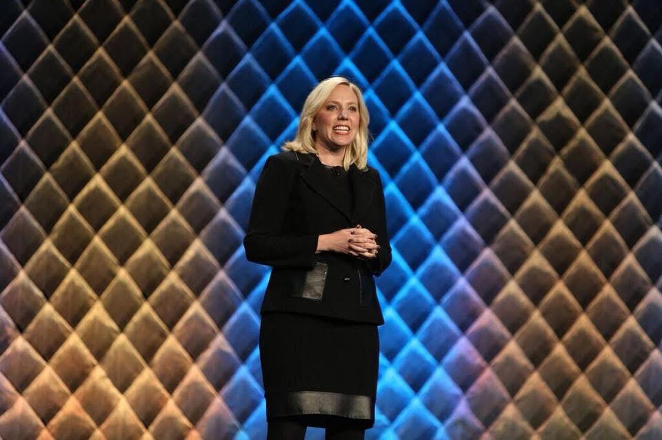 Heather Rim speaking on stage at a conference