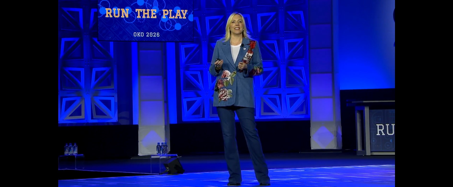 Heather Rim speaking on stage at a leadership event